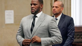 In this June 6, 2019, file photo, singer R. Kelly pleaded not guilty to 11 additional sex-related felonies during a court hearing before Judge Lawrence Flood at Leighton Criminal Court Building in Chicago. An updated federal indictment filed on Friday, Feb. 14, 2020, in Chicago, refers to yet another minor accusing R. Kelly of sexual misconduct, adding to the jailed singer's mounting legal challenges across three states.