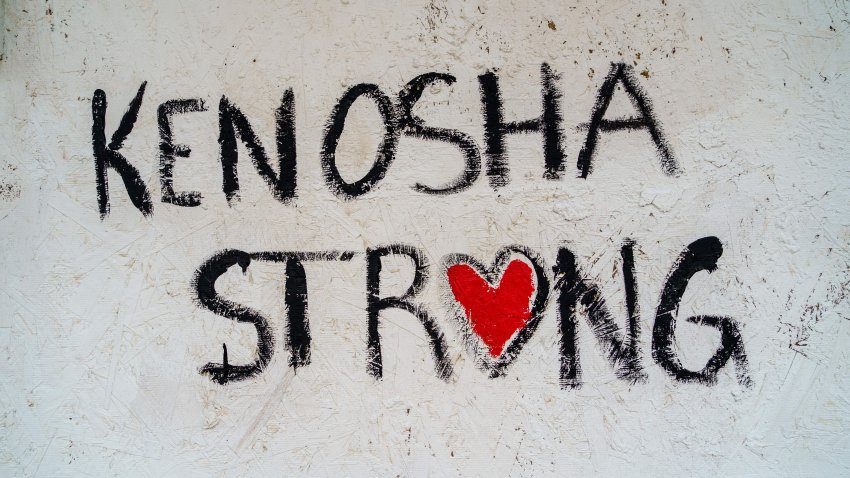 Words painted by the Reverend Jesse Jackson are seen on a wooden chipboard-covered door on August 27, 2020 in Kenosha, Wisconsin, after holding a press conference to address the police shooting of Jacob Blake, Jr., on August 23. – A strong police presence brought relative calm to the Midwestern US city of Kenosha early on August 27 after three nights of violence over the police shooting of a black man, as NBA stars led the sporting world in a wave of protest against racism. (Photo by Kerem Yucel / AFP) (Photo by KEREM YUCEL/AFP via Getty Images)