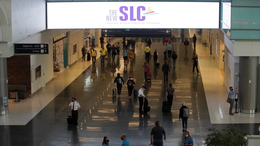 Travelers wearing protective masks walk through the main corridor of Terminal A on opening day of the Salt Lake City International Airport in Salt Lake City, Utah, U.S., on Tuesday, Sept. 15, 2020. The $4.1 billion replacement of the old Salt Lake City International Airport, which is slated to be demolished and built over starting by the end of the year, opened its doors for the first time Tuesday to travelers. Photographer: George Frey/Bloomberg via Getty Images