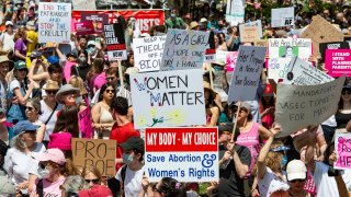 Activists demonstrate during a Planned Parenthood pro-abortion rights rally in Boston on Saturday, May 14, 2022.