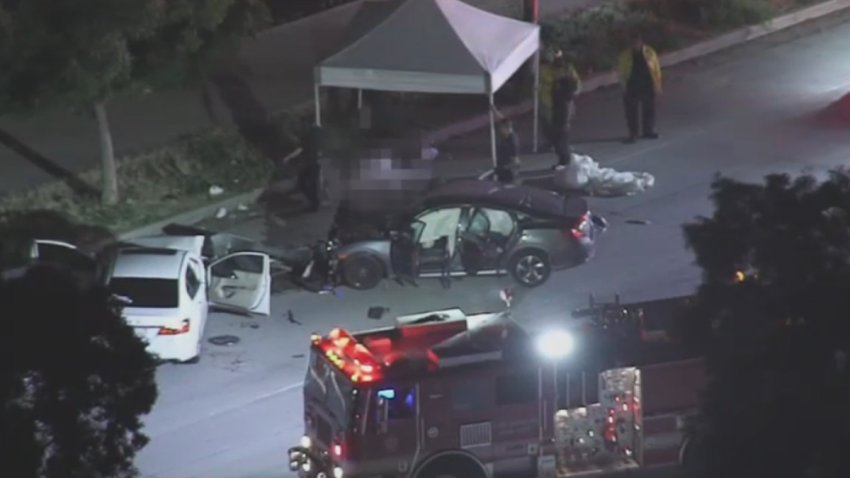 An aerial view of two crashed cars as investigators set up a tent over a dead body following a crash in Van Nuys.