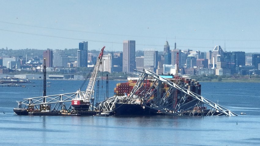 BALTIMORE, MARYLAND – APRIL 26:  In this aerial view, salvage crews continue to remove wreckage from the Dali one month after the cargo ship collided with the Francis Scott Key Bridge and caused it to collapse on April 26, 2024 in Baltimore, Maryland. Four weeks since the maritime accident in the Patapsco River, a temporary channel opened this week to allow ships stuck in the Port of Baltimore to leave.  (Photo by Chip Somodevilla/Getty Images)