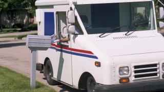 Mail being deliver in a neighborhood.