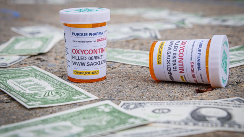 MANHATTAN, NEW YORK, UNITED STATES – 2021/08/09: Oxy Dollars and prescription bottles of OxyContin seen dropped outside the courthouse. Members of P.A.I.N. (Prescription Addiction Intervention Now), Truth Pharm, and a coalition of survivors and advocacy groups working in response to the overdose crisis held a demonstration outside of The United States Bankruptcy Court in White Plains to call out the United States justice system for allowing the billionaire Sackler Family to walk away unscathed after igniting one of the worst public health care scandals in the history of the nation. (Photo by Erik McGregor/LightRocket via Getty Images)