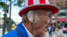 MILWAUKEE, WISCONSIN - JULY 17: A Donald Trump supporter and performer places a bandage over his ear in reference to Trump's wound at the Republican National Convention (RNC) on the third day of the convention on July 17, 2024 in Milwaukee, Wisconsin. Security throughout downtown Milwaukee remains high following the assassination attempt on former President Donald Trump over the weekend. Thousands of delegates, politicians and the Republican faithful are arriving into the traditionally Democratic city over the next few days for the annual convention which will conclude with former President Donald Trump accepting his party's presidential nomination. The RNC takes place from July 15-18. (Photo by Spencer Platt/Getty Images)