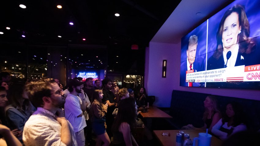 People attend a watch party for the US Presidential debate between Vice President and Democratic presidential candidate Kamala Harris and former US President and Republican presidential candidate Donald Trump at The Admiral in Washington, DC, on September 10, 2024. (Photo by Allison Bailey / AFP) (Photo by ALLISON BAILEY/AFP via Getty Images)