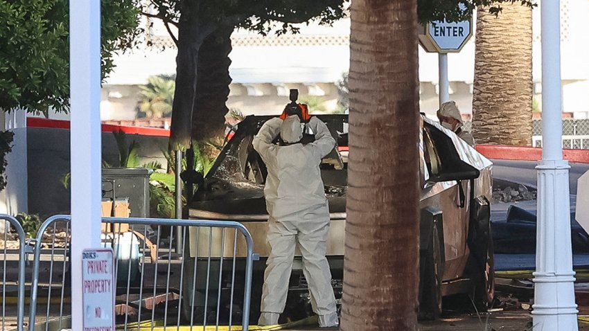 TOPSHOT – An investigator photographs a Tesla Cybertruck that exploded outside the lobby of President-elect Donald Trump’s hotel on January 1, 2025, in Las Vegas. At least one person was killed and seven wounded when a Tesla Cybertruck exploded outside a hotel belonging to US President-elect Donald Trump in Las Vegas, police said Wednesday. (Photo by WADE VANDERVORT / AFP) (Photo by WADE VANDERVORT/AFP via Getty Images)