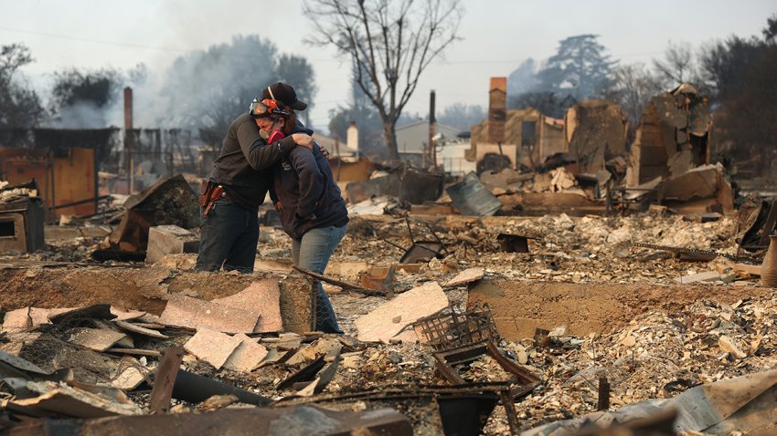 ALTADENA, CALIFORNIA – JANUARY 09: Khaled Fouad (L) and Mimi Laine (R) embrace as they inspect a family member’s property that was destroyed by Eaton Fire on January 09, 2025 in Altadena, California. Fueled by intense Santa Ana Winds, the Eaton Fire has grown to over 10,000 acres and has destroyed many homes and businesses. (Photo by Justin Sullivan/Getty Images)