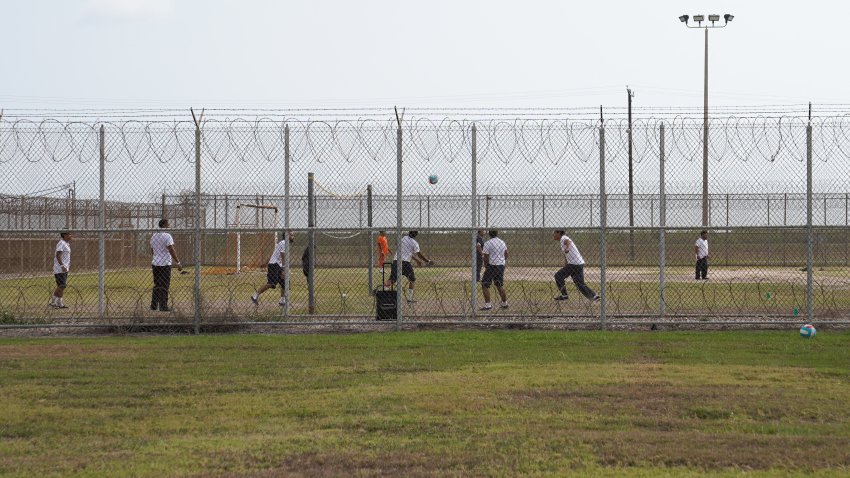 Detainees play outside during a media tour of the Port Isabel Detention Center (PIDC), hosted by U.S. Immigration and Customs Enforcement (ICE) Harlingen Enforcement and Removal Operations (ERO), in Los Fresnos, Texas, June 10, 2024. Behind barbed metal fences topped with barbed wire, men play volleyball and basketball at a detention center in Texas, passing time as they wait to hear if they will be allowed to stay in the United States. They are among more than 1,000 housed at this former naval base in the US city of Los Fresnos, just a few miles from the Mexican border, which they all crossed illegally. (Photo by Veronica G. Cardenas / POOL / AFP) (Photo by VERONICA G. CARDENAS/POOL/AFP via Getty Images)