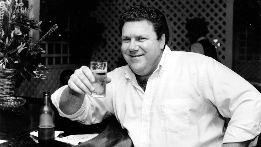 Actor George Wendt holds a glass of beer in a barroom in Los Angeles, Calif., on June 13, 1983.