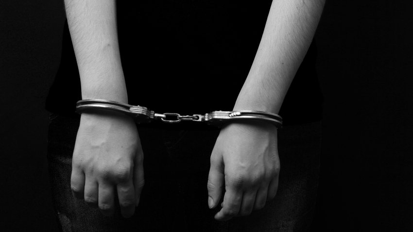 men and women cuffed hands together