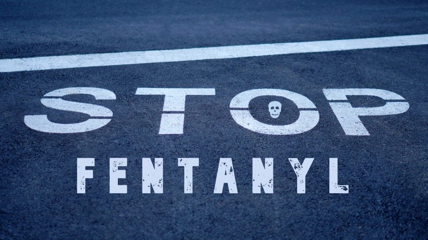 Stop fentanyl. global health issue. words written on a stop sign on the road pavement.