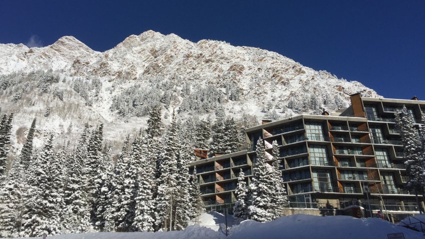 Winter mountain landscape with a snow-covered peak and modern resort in Snowbird, Utah