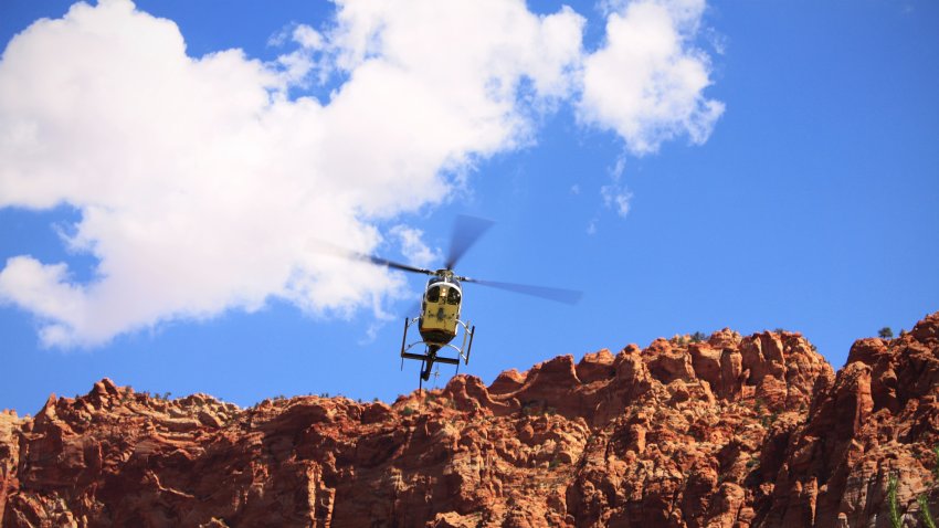 Rescue Helecopter hovering over cliffs in southern Utah