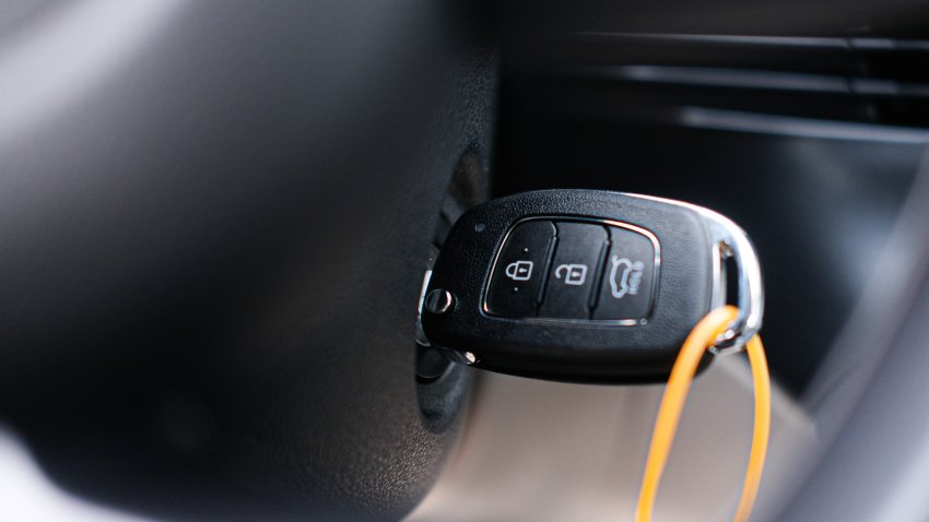 Starting the car – car key in ignition lock stock photo