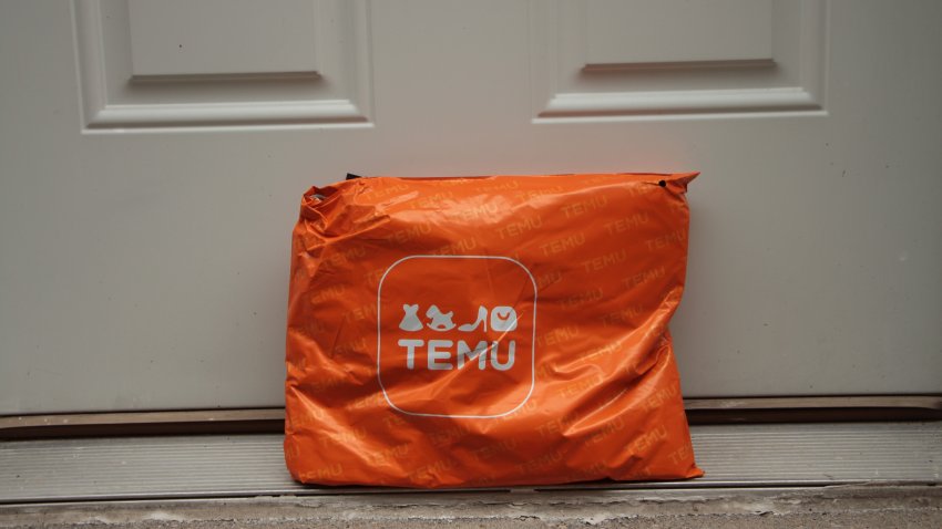 tor, canada – July 20, 2023: temu orange rectangle bag package with logo on it delivery delivered leaning against white door