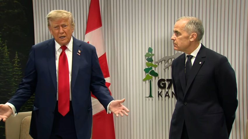 President Donald Trump stands next to Canadian Prime Minister